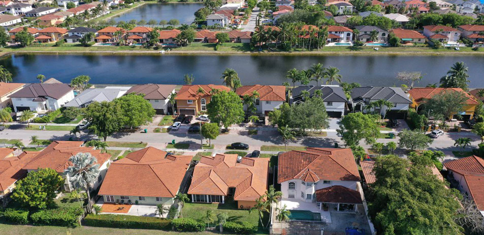 Aerial view showcasing a neighborhood filled with various houses and green spaces, highlighting community layout and design.