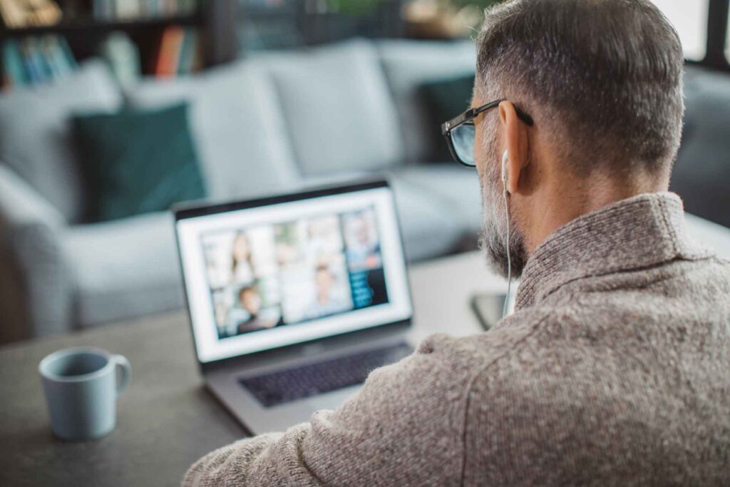 Man attending an investment webinar on their laptop.